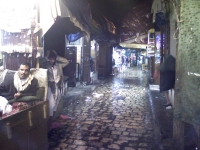 The narrow alleys in old San'a market quickly empty during a sudden downpour