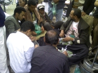 Locals haggling with a qat seller who is carrying his traditional ghambia